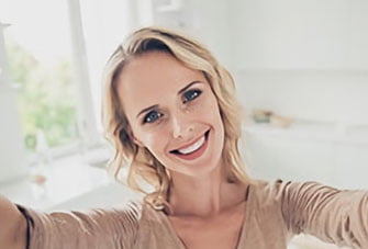 Woman smiling and taking a selfie